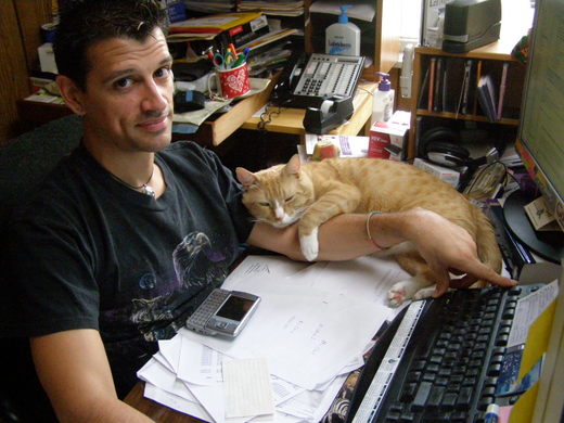 Matthew Perosi with his cat holding his arm